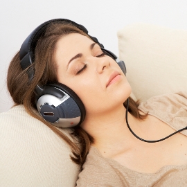 woman in beige with headphones